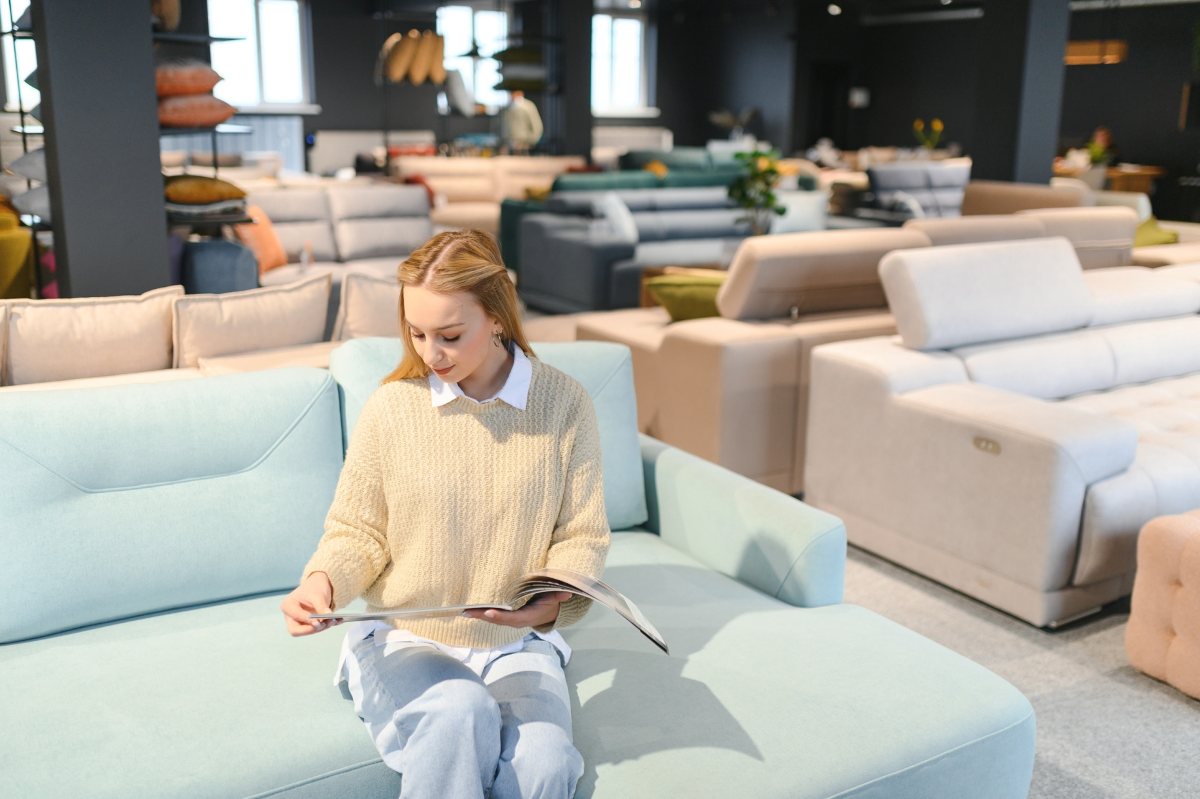 woman sitting on a sofa in a furniture store